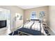 Stylishly furnished bedroom with a striped comforter, blue accent rug and lots of natural light at 9254 Reymont St, Orlando, FL 32827
