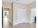 Spacious bedroom with tile flooring and a double door closet provides ample storage space at 9254 Reymont St, Orlando, FL 32827