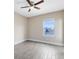 Sunny, minimalist bedroom with wood-look flooring and a large window, great natural light at 9254 Reymont St, Orlando, FL 32827