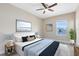 Comfortable bedroom featuring a ceiling fan, neutral walls, and serene beach-themed artwork at 9254 Reymont St, Orlando, FL 32827