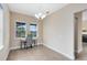 Charming dining area with a chandelier, a desk near a window, and view of a pool at 9254 Reymont St, Orlando, FL 32827