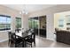 Bright dining area with modern chandelier, table, and chairs adjacent to the outdoor patio at 9254 Reymont St, Orlando, FL 32827