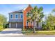 Beautiful exterior view of a two story home with a brick driveway and a large palm tree at 9254 Reymont St, Orlando, FL 32827