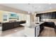 Modern kitchen featuring granite countertops, stainless steel appliances, and wood-look tile floors at 9254 Reymont St, Orlando, FL 32827
