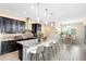 Well-equipped kitchen features granite counters, an island with bar seating, and stainless steel appliances adjacent to dining area at 9254 Reymont St, Orlando, FL 32827