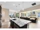 Modern kitchen featuring granite countertops, stainless steel appliances, and an island at 9254 Reymont St, Orlando, FL 32827