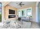 Cozy lanai with a stone accent wall and fireplace, perfect for relaxing and entertaining at 9254 Reymont St, Orlando, FL 32827