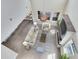 Aerial view of the living room shows spacious seating, a fireplace, natural light, and seamless flow to the dining area at 9254 Reymont St, Orlando, FL 32827