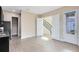 Bright, neutral living room with wood-look flooring, light paint, and access to the stairs and exterior at 9254 Reymont St, Orlando, FL 32827