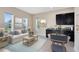 Bright living room with neutral tones, complemented by a wet bar and picturesque views at 9254 Reymont St, Orlando, FL 32827