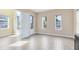 Light-filled living space featuring wood-look tile flooring and a doorway to the exterior of the home at 9254 Reymont St, Orlando, FL 32827