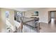 Open loft area with iron railing, a TV, and views of the neighborhood at 9254 Reymont St, Orlando, FL 32827