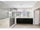 Spacious main bathroom featuring a large walk-in shower and double vanity with dark cabinets at 9254 Reymont St, Orlando, FL 32827