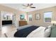 Serene main bedroom featuring neutral tones, wood-look floors, and a connecting bathroom at 9254 Reymont St, Orlando, FL 32827