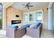 Cozy outdoor seating area with stone fireplace and view of backyard at 9254 Reymont St, Orlando, FL 32827