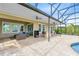 Screened-in patio with comfortable seating and an outdoor kitchen perfect for relaxing and entertaining at 9254 Reymont St, Orlando, FL 32827