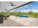 Inviting screened-in pool area with outdoor kitchen and bar seating at 9254 Reymont St, Orlando, FL 32827