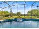 Sparkling pool with a waterfall feature and stunning backyard views at 9254 Reymont St, Orlando, FL 32827