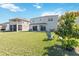 Large backyard with well-manicured lawn, mature landscaping, and patio area at 9826 Heron Pointe Dr, Orlando, FL 32832