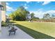 Spacious backyard featuring a well-kept lawn, trees, and outdoor seating for relaxing at 9826 Heron Pointe Dr, Orlando, FL 32832