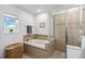 Bathroom featuring a tiled shower, and soaking tub with a bright window view at 9826 Heron Pointe Dr, Orlando, FL 32832