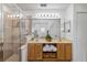 Bright bathroom with a glass enclosed shower and double vanity sink with storage at 9826 Heron Pointe Dr, Orlando, FL 32832