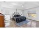 Bright bedroom showcasing a large bed, ceiling fan, wood-look floors and golf course view at 9826 Heron Pointe Dr, Orlando, FL 32832