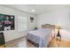 Cozy bedroom with light wood floors, a queen bed, and a ceiling fan for added comfort at 9826 Heron Pointe Dr, Orlando, FL 32832