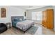 Well-lit bedroom featuring wood floors, a comfortable bed, and a large window at 9826 Heron Pointe Dr, Orlando, FL 32832