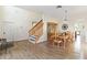 Open-concept room with dining area, staircase, and hardwood floors at 9826 Heron Pointe Dr, Orlando, FL 32832