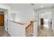 Upstairs hallway with wooden railing, white walls and doors, and wood-look flooring at 9826 Heron Pointe Dr, Orlando, FL 32832