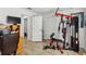 Bright home gym area featuring a multi-station workout machine and wood-look floors at 9826 Heron Pointe Dr, Orlando, FL 32832