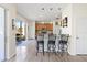 Kitchen island with bar stool seating, stainless appliances, and sliding glass door at 9826 Heron Pointe Dr, Orlando, FL 32832