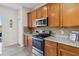 Kitchen features granite countertops, stainless appliances, and tile backsplash at 9826 Heron Pointe Dr, Orlando, FL 32832
