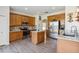Well-equipped kitchen with an island, stainless steel appliances, and light wood cabinets at 9826 Heron Pointe Dr, Orlando, FL 32832