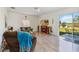 Bright living room with wood-look flooring, fireplace, and sliding glass doors to the outdoor space at 9826 Heron Pointe Dr, Orlando, FL 32832