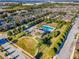 Aerial view showcases community pool, clubhouse, playground, and colorful townhomes at 1197 Tallow Rd, Apopka, FL 32703
