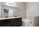Bathroom featuring double sink vanity, soaking tub, and neutral paint at 1197 Tallow Rd, Apopka, FL 32703