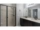 Bathroom with double sink vanity, large mirror, and walk-in shower with decorative tile and glass door at 1197 Tallow Rd, Apopka, FL 32703