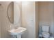Charming powder room with a pedestal sink, oval mirror, and tile flooring at 1197 Tallow Rd, Apopka, FL 32703