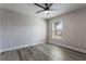 Bright bedroom featuring wood-look flooring, a window, and a modern ceiling fan at 1197 Tallow Rd, Apopka, FL 32703