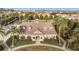 Aerial view of community center with clubhouse, palm trees, manicured landscaping, and walking path at 1197 Tallow Rd, Apopka, FL 32703