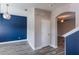 Stylish entryway boasts wood-look floors, striking blue accent wall, and white trim at 1197 Tallow Rd, Apopka, FL 32703