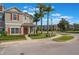Charming townhouse featuring a red door, well-maintained landscaping, and a covered porch at 1197 Tallow Rd, Apopka, FL 32703