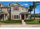 Inviting townhouse with red shutters, manicured landscaping, and a charming front porch at 1197 Tallow Rd, Apopka, FL 32703