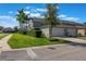 View of townhouse featuring a two-car garage, well-maintained lawn, and neatly trimmed bushes at 1197 Tallow Rd, Apopka, FL 32703