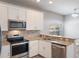 Well-equipped kitchen boasts stainless steel appliances, granite countertops, and ample storage at 1197 Tallow Rd, Apopka, FL 32703