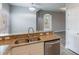 Modern kitchen with stainless steel appliances and granite countertops overlooking an open floorplan at 1197 Tallow Rd, Apopka, FL 32703