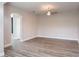 Spacious living room with ceiling fan, wood-look floors, and neutral paint at 1197 Tallow Rd, Apopka, FL 32703