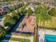 Community playground with various play structures, bordered by green landscaping and the pool at 1197 Tallow Rd, Apopka, FL 32703